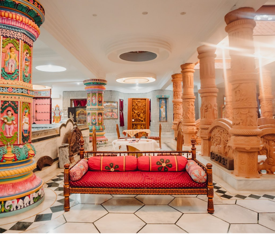 Colorful lobby with ornate pillars and red couch