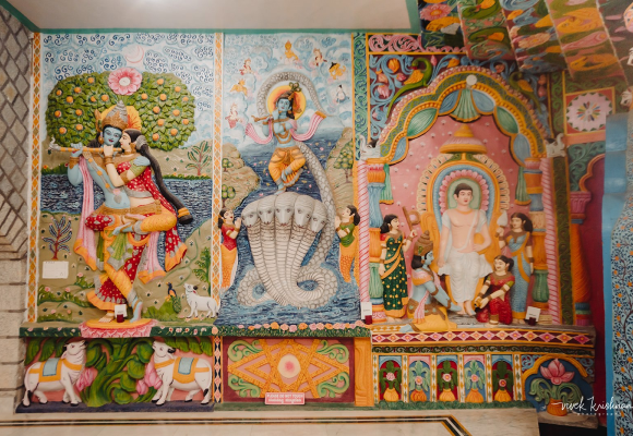 Colourful carved sculptures on the wall of Omtara Kuteera Heritage Resort
